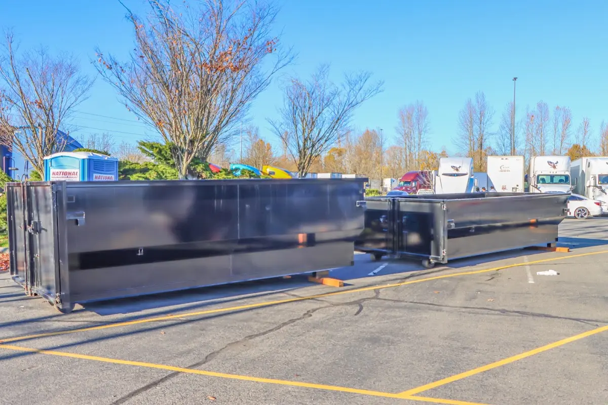 Professional dumpster rental service with roll-off container on residential driveway in Hurst